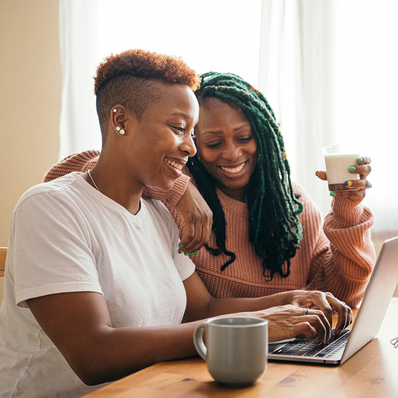 Black lesbian couple in their kitchen preparing for online couples therapy in California, Oregon and Washington