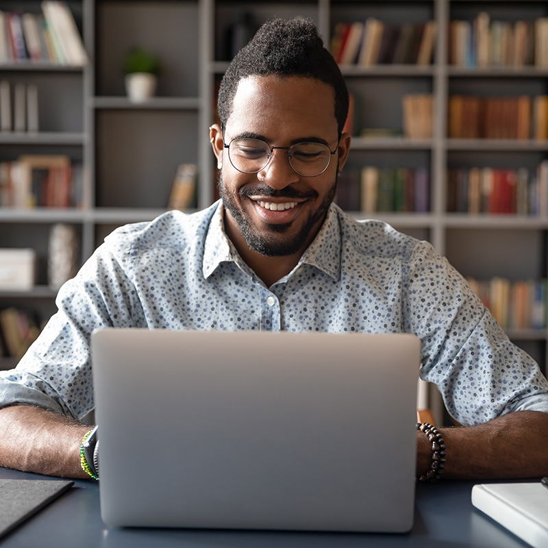 Black man in front of a laptop, for teletherapy in California, Oregon, and Washington